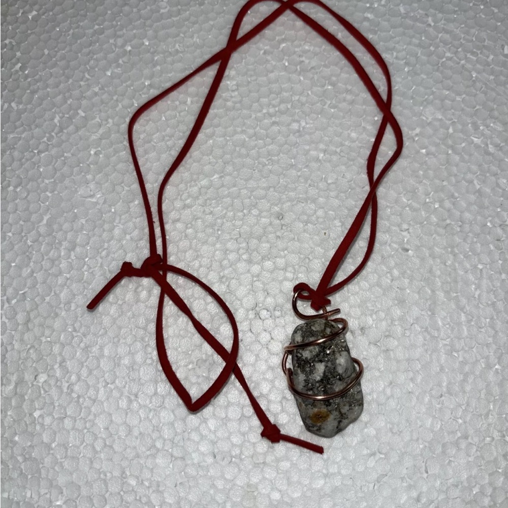 Wire hand wrapped rock stone with copper and red leather. Hand selected rocks